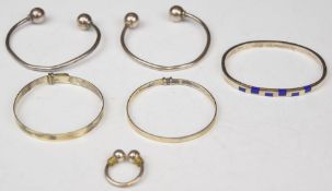 Five silver bangles, one set with lapis lazuli, and a silver ring