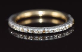 A c1880 yellow metal eternity ring set with old cut diamonds in a silver setting, 2.9g, size N