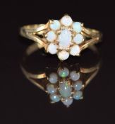 A 9ct gold ring set with opals in a cluster, 2.1g, size O