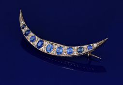Victorian yellow metal crescent brooch set with nine oval cut graduated sapphires, the centre