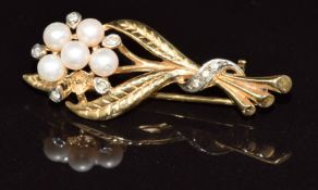 A 9ct gold brooch in the form of a flower set with cultured pearls and diamonds (one pearl