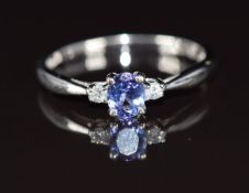 A 9ct white gold ring set with an oval cut tanzanite and diamonds, 1.3g, size L/M
