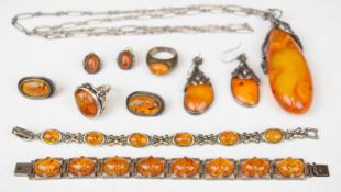 Eight pieces of silver jewellery set with pressed amber including two bracelets, three pairs of