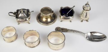 Hallmarked silver items comprising three napkin rings, Mappin & Webb three piece cruet set and a
