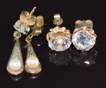 Two pairs of 9ct gold earrings, one pair set with topaz and a pearl and the other cubic zirconia,