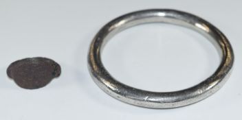 A possibly Celtic / Anglo Saxon hammered silver bangle, diameter 7cm, together with a possibly