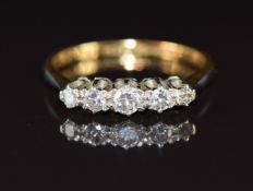 An 18ct gold ring set with five diamonds in a platinum setting, 2.8g, size N