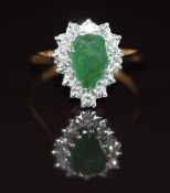 An 18ct gold ring set with a pear cut emerald of approximately 1ct surrounded by diamonds, 3.7g,