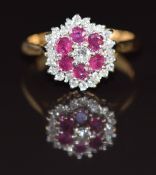 An 18ct gold ring set with rubies and diamonds in a cluster, 4.2g, size M