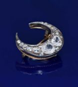 Victorian crescent shaped brooch set with old cut diamonds, the largest two diamonds approximately