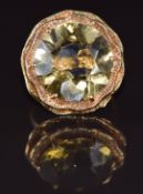 A 9ct gold ring set with a round cut quartz in a two tiered textured setting, 7.5g, size N