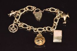 A 9ct gold charm bracelet with five 9ct gold charms including Masonic charm, bell, man with