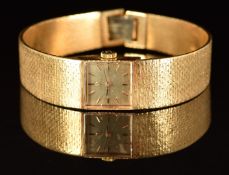 Omega 18ct gold ladies wristwatch with black hands, gold hour markers, silver dial and signed 17