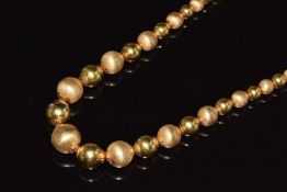 An 18ct gold necklace made up of alternating polished and textured sphere links, 26.4g, 40cm