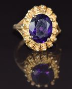 A 9ct gold ring set with an oval cut amethyst of approximately 3.9g with textured border, 7g, size