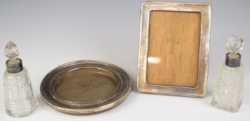 Two hallmarked silver photograph frames, one circular Birmingham 1919, maker Boots Pure Drug