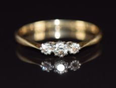 An 18ct gold ring set with three diamonds, 1.9g, size P
