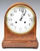 Late 19th or early 20thC mahogany cased mantel clock raised on four turned feet, the white enamel