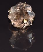 A 9ct gold ring set with a star cut smoky quartz, 7.8g, size L