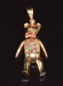 A 9ct gold articulated pendant in the form of a teddy bear set with rubies and emeralds, 12.2g, 4cm
