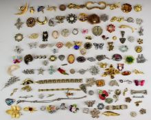 A collection of vintage brooches including filigree, white metal example depicting an elephant,