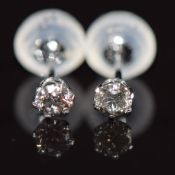 A pair of platinum earrings each set with a diamond of approximately 0.10ct, 0.3g