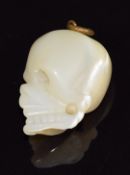 A mother of pearl c1900 charm in the form of a skull, 5.5g, 2cm