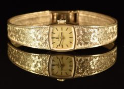Omega 9ct gold ladies wristwatch with black hands and hour markers, gold dial and signed 17 jewel