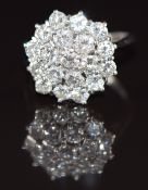 An 18ct white gold ring set with a cluster of 18 round cut diamonds, each approximately 0.1ct, 5.4g,