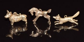 Three 9ct gold charms in the form of a horse, corgi and fox, 9.1g