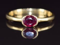 An 18ct gold ring set with an oval cut ruby of approximately 0.7ct, 3.8g, size R