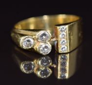 An 18ct gold ring set with seven diamonds in a bespoke design, the total diamond weight