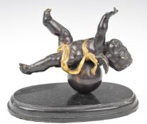 After Auguste Moreau bronze figure of a cherub on a globe, impressed 'Aug Moreau', height 16cm