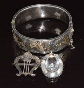 A hallmarked silver bangle with applied gold decoration, Victorian silver brooch / pendant and