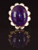 An 18ct gold ring set with an amethyst cabochon measuring approximately 19.7 x 15.2mm, 8.5g, size N