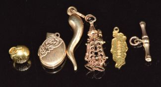 A 9ct gold locket, 9ct gold chilli pendant, 9ct gold clown pendant, 10k gold 'Tobago' charm, 9ct
