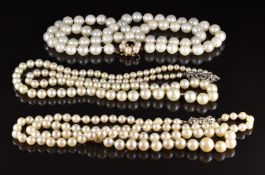 Three cultured pearl necklaces, including one with a silver clasp and another with 9ct gold clasp