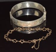 A 9ct gold bracelet made up of heart links (2.4g, 18cm) and a silver bangle with scrolling
