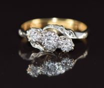 An 18ct gold ring set with three diamonds in a platinum twist setting, 2.7g, size K