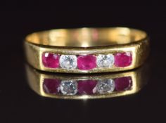 An 18ct gold ring set with three rubies and two diamonds, 3.2g, size S