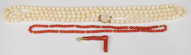 A double strand angel coral necklace, the 14k gold clasp set with a carved coral flower, a single
