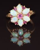 A 9ct gold ring set with rubies and opals in a daisy cluster, 3.1g, size I/J