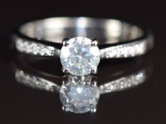 An 18ct white gold ring set with a round brilliant cut diamond of approximately 0.59ct with