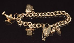 A 9ct gold charm bracelet with four 9ct gold charms including boots, telephone, purse and lantern,