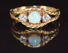 An 18ct gold ring set with an opal and two round cut diamonds, each approximately 0.08ct, in a