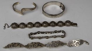 Four silver bracelets and a silver bangle by Excalibur