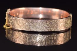 A 9ct rose gold bangle with engraved scrolling decoration, Chester 1919, 16g, 6 x 5cm