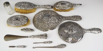 Hallmarked silver mounted items comprising two hand mirrors, one with decoration of three Art