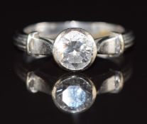 An 18ct white gold ring set with a round brilliant cut diamond of approximately 1ct, 4.7g, size M