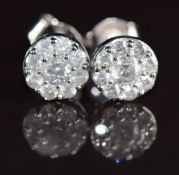 A pair of 9ct white gold earrings set with diamonds totalling approximately 0.71ct, 1.7g